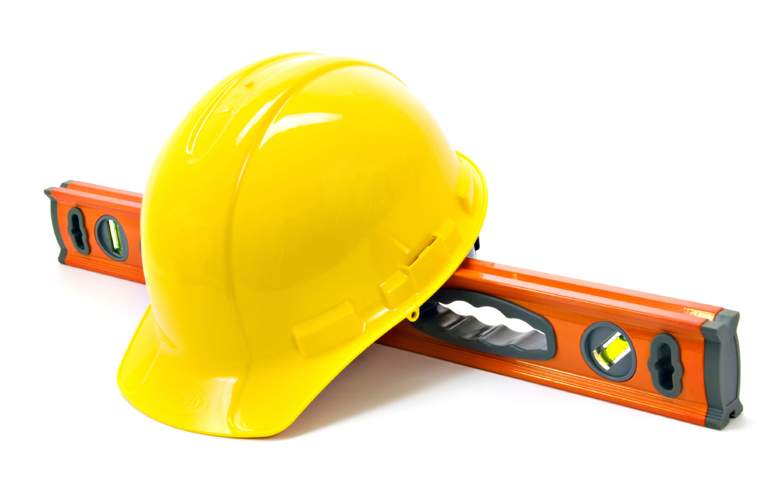 Hard hat and level tool used by general contractors at D&S Elite Construction