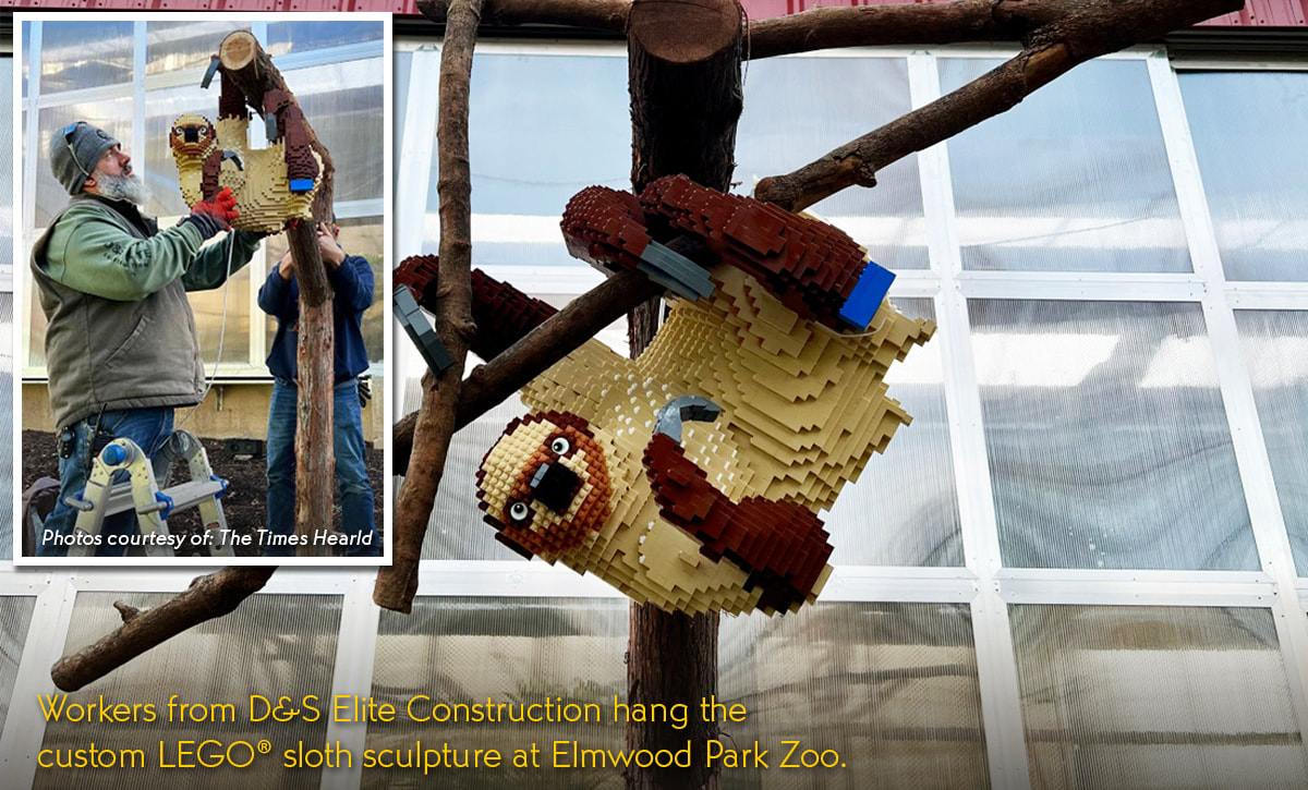 Lego Liana at the Elmwood Park Zoo. Workers from D&S Elite Construction hang the custom LEGO® sloth sculpture at Elmwood Park Zoo.